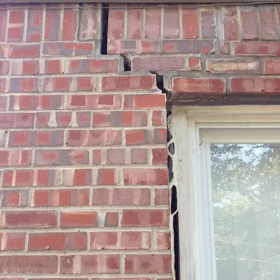 Diagonal crack in exterior brick wall of a North Texas home