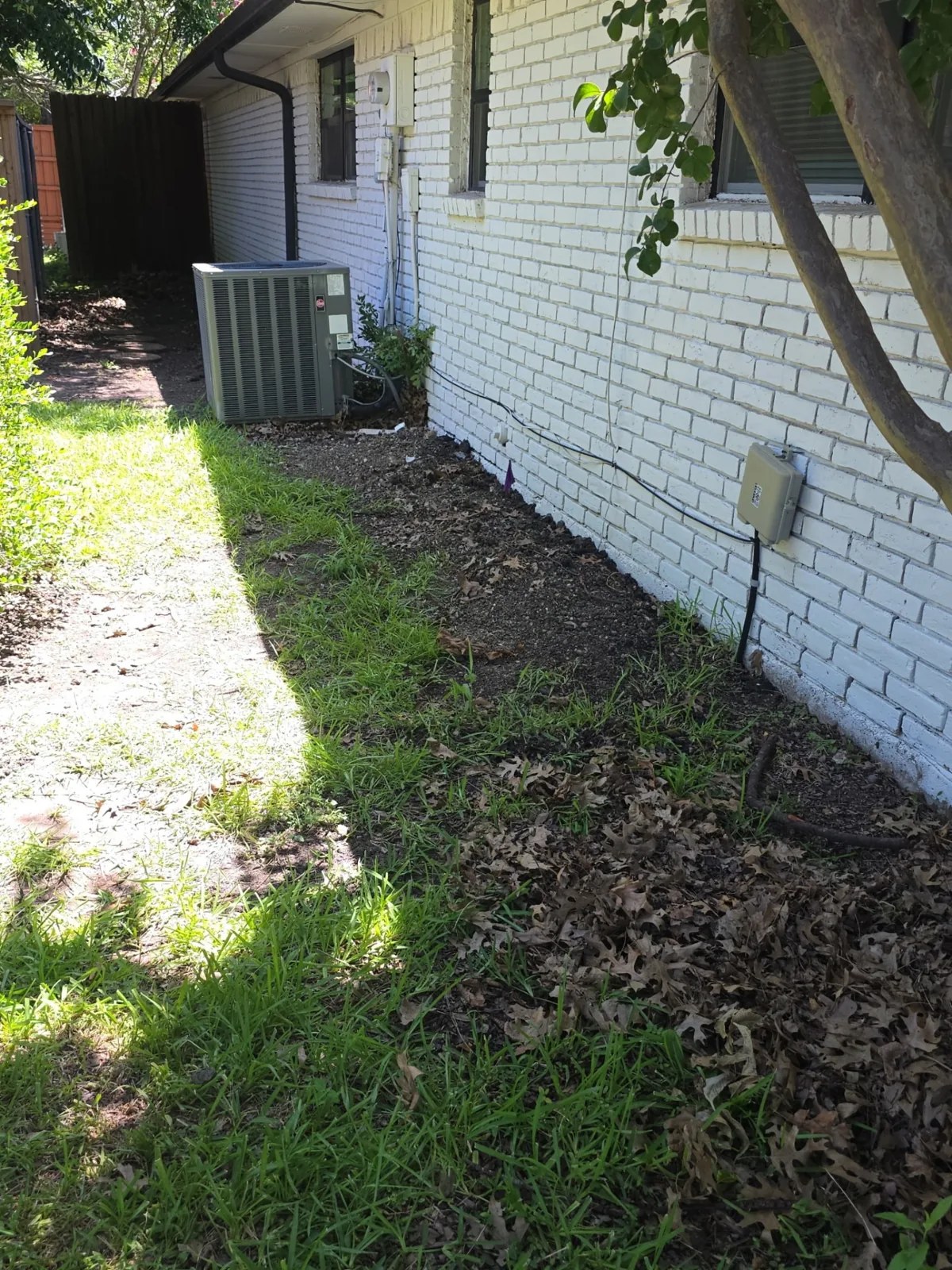 Same side of the home after foundation repair with the work area backfilled and cleaned up